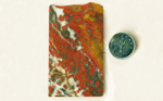 Red flower-patterns in a black, yellow and white slab of Morgan Hill Poppy Jasper from California.