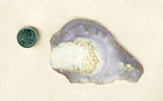 Slab of purple and violet Luna Agate from Mexico, with a colorful background and bright orbs in the foreground.