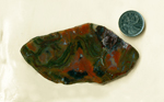 Red and green Christmas Flame Agate from Mexico, with curving stripes running through it.