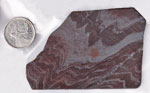 Flowing metallic reddish, silver and black patterns in a slab of Tiger-Iron from Australia.