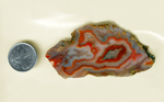 A Laguna Agate slab from Mexico, blue with a bubbly waving red pattern spread across it, with a red fortification in the center.