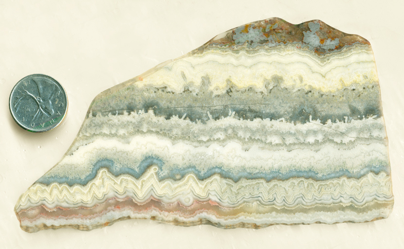 Blue, red and gold slab of Mexican Dogtooth Lace Agate from Mexico, with tooth and lace patterns.