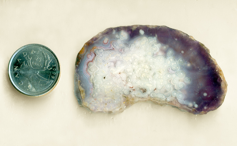 Purple, blue and white slab of Luna Agate from Mexico, with star patterns in a deep background.