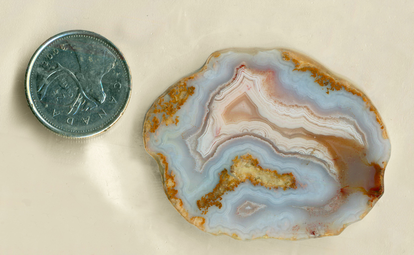 Blue, yellow, pink and orange slab of Mexican Snowball Agate, with two fortification patterns.