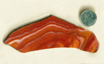 Yellow, brown, red, pink and white flowing lines in a slab of Mexican Hickoryite (Aztec Miracle Stone), a type of Rhyolite.