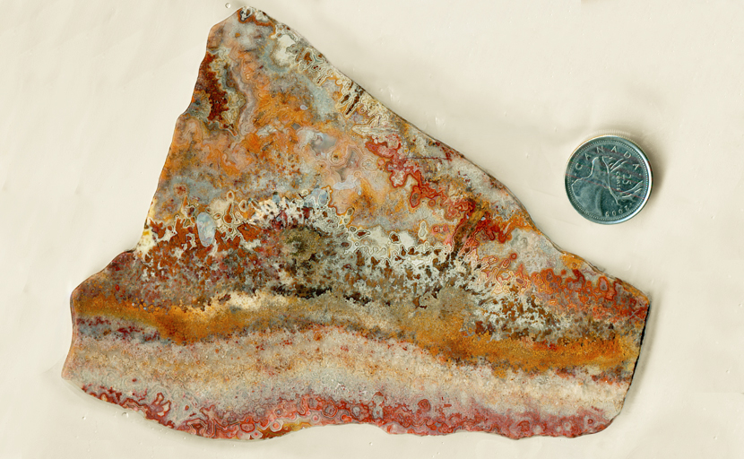 A mad landscape of yellow, red, orange and white lace patterns in a slab of Crazy Lace Agate from Mexico.