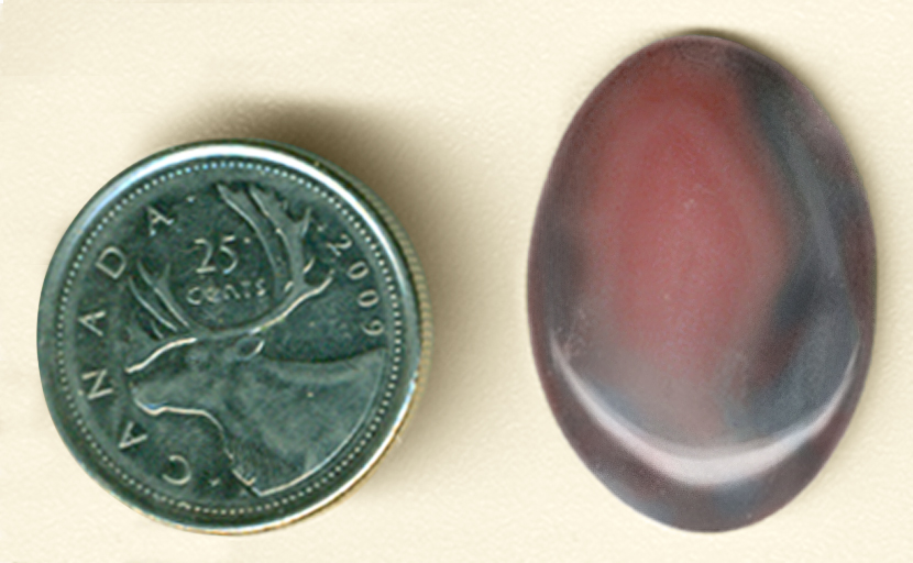 Orangey-pink hazy flame pattern on a background of blue and purple in a cabochon of Botswana Agate from Africa.
