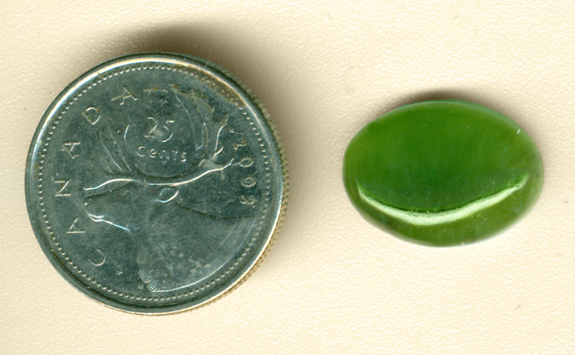 Grass-green oval Nephrite Jade cabochon, with grass-like details.