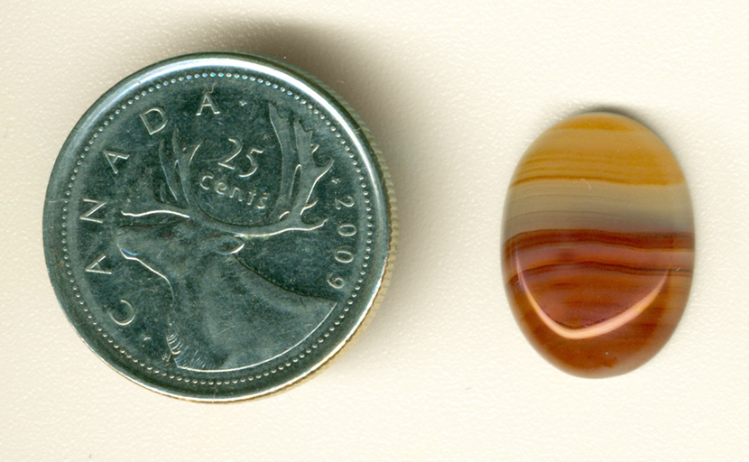 Red, yellow and clear streaks in a cabochon of Agate from Uruguay.