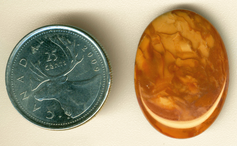 Creamy reddish-brown cabochon of Bruneau Jasper from Idaho, patterned like layers of cloud.