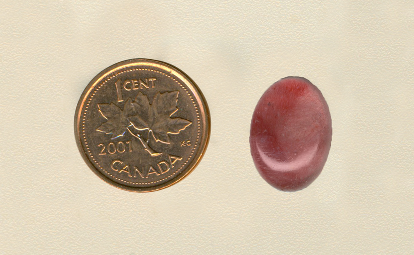 Calibrated polished Strawberry Quartz cabochon from Mexico, with dark and light shades of pink needles in sections across its surface.