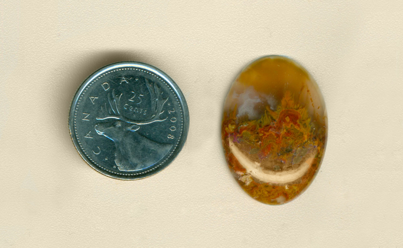 Calibrated oval polished Flame Agate cabochon from Mexico, with yellow flames shooting up from a red layer into a transparent smoky layer, and a light blue fortification.