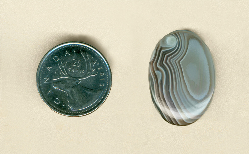 Calibrated polished Botswana Agate from Africa, brown and blue arranged in layers, with orbs of pure blue.