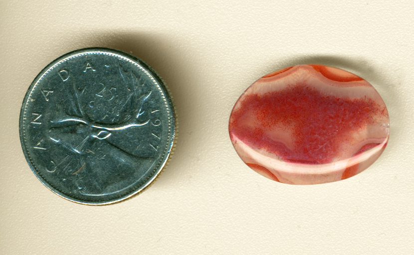 Raspberry-red fortification pattern in a clear cabochon of Laguna Agate from Mexico.