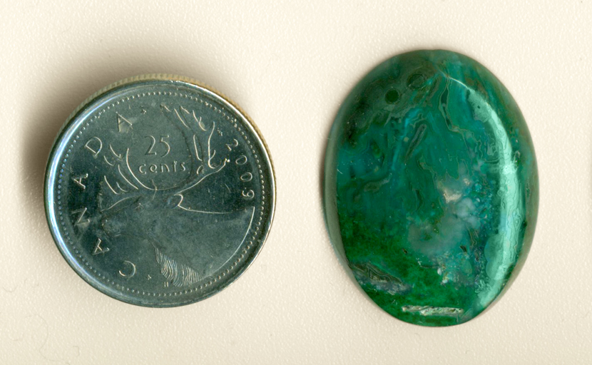 Bright blue and green streamers preserved by agate in a cabochon of Chrysocolla-in-Chalcedony.