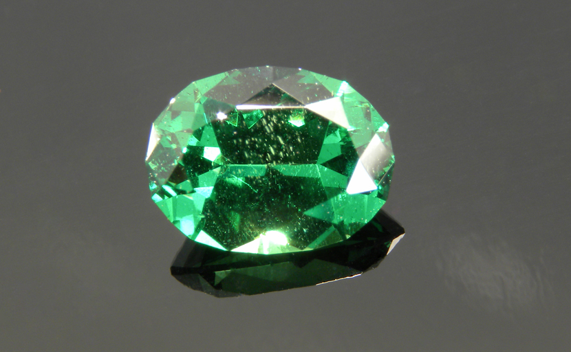 Oval faceted Tsavorite (Grossularite) Garnet from Tsavo in Kenya, bright slightly yellowish green, well-cut with good light return.