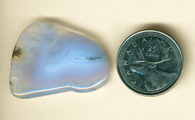 Powder-blue fortification pattern and transparent lace in a freeform polished Mexican Blue Agate.