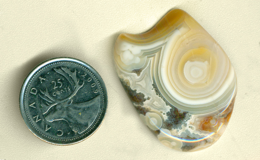 Large yellow eye pattern in blue, orange and gray fortified Crazy Lace Agate polished freeform from Mexico.
