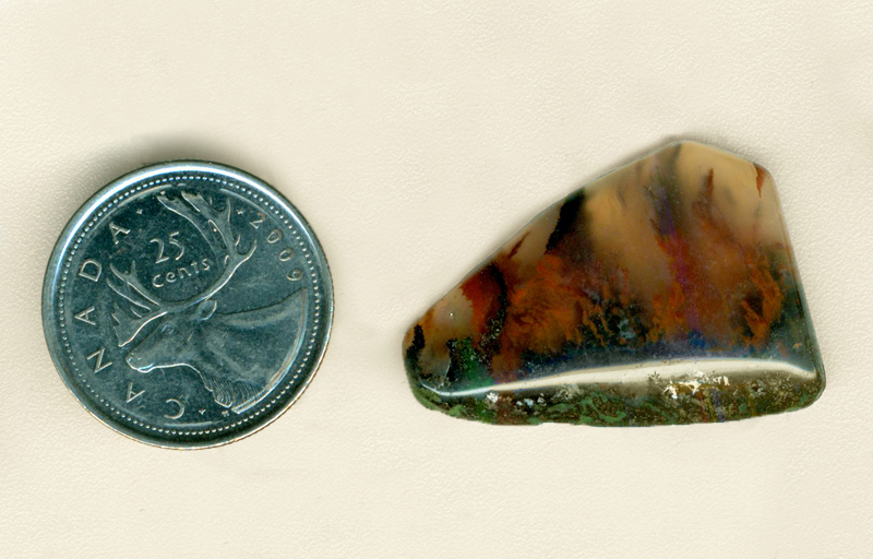 Freeform polished Mexican Flame Agate cabochon, with b;ack and red flames coming up from a black ground into clear chalcedony.
