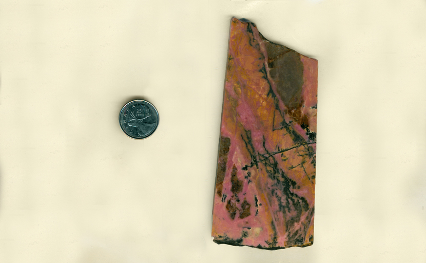 A rectangular slab of Rhodonite from West Virginia, streaked with pink, yellow and black.