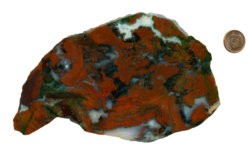 A slab of red, green and blue Christmas Flame Agate from Mexico, patterned all over with wide brush-strokes of strong color.