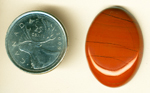 Red Jasper cabochon from Africa, with black striations and ovoid details.