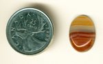 Red, yellow and clear streaks in a cabochon of Agate from Uruguay.