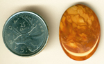 Creamy reddish-brown cabochon of Bruneau Jasper from Idaho, patterned like layers of cloud.