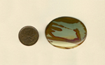 Calibrated polished Owyhee Picture Jasper cabochon from Idaho, with reddish-brown patterns on top of blue sky and yellow sand.