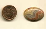 Calibrated oval polished Fairburn Agate cabochon from Nebraska or South Dakota, with successive layers of orange, blue, purple and yellow.