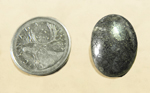 Polished cabochon of agate, full of silvery metallic marcasite inclusions.