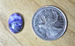 Purple, swirling, lustrous cabochon of Charoite from Siberia.