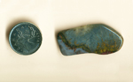 Mexican Sagenite Lace Agate, with orange streaks going up into a blue-gray background, and red marks beneath them.