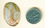 Pattern of an upward-pointing arrow in an orange, green, yellow, blue  and pink freeform Crazy Lace Agate from Mexico.