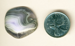 White, purple and gray fortification patterns in a freeform cabochon of Parcelas Agate from Mexico.