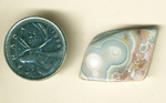 Blue section with white eyes and a red-brown space in a freeform polished Structural Eye Agate from Mexico.