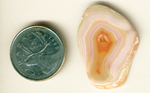 Concentric layers of orange, pink, purple, yellow and blue in a freeform polished Moctezuma Agate from Mexico.