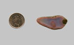 A freeform polished Fortification Agate from Mexico, pink around the outside, and with fortifications of pink lining the inner space.