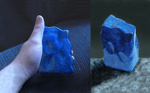 Standing carving of deep blue Lapis Lazuli from Afghanistan, polished on every surface, striped on one side and with solid color on the other, and flecks of iron pyrite all over it.