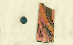 A rectangular slab of Rhodonite from West Virginia, streaked with pink, yellow and black.