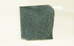 A square slab of Nephrite Jade from Wyoming, dark green mottled with lighter color.
