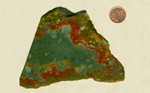 A slab of scenic Rocky Butte Jasper from Oregon, with a blue-green sky and red ground on three sides, with green patterns underneath.