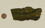 A dark, dense stone, lined with bright yellow, green and reddish-brown.