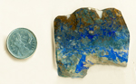 Shattuckite and Ajoite slab with lines and splashes of lapis-blue and green across a brown and tan background.