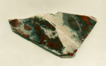 Earthy reds and brown mottled patterns on a triangular Jaspalite slab from Africa